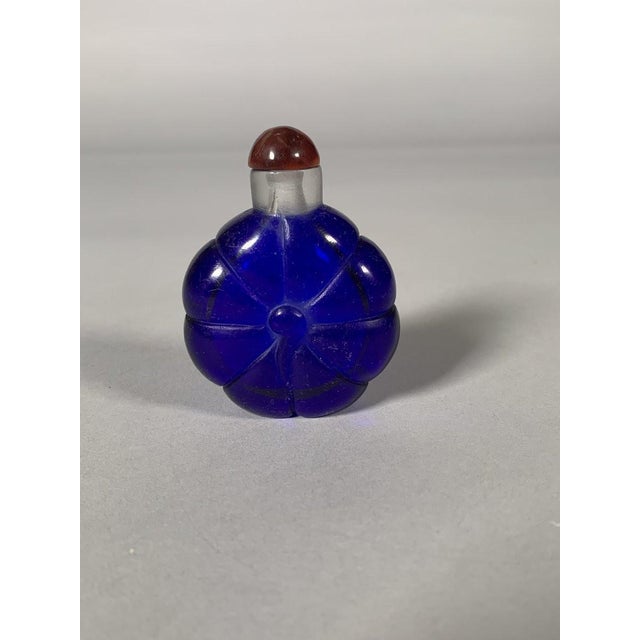 Snuffbox with a gourd motif, made of blue Peking glass with a translucent neck, China, 20th century . Red glass stopper...
