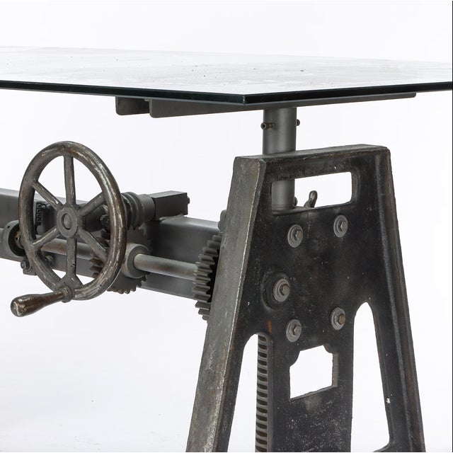 Industrial dining table with raising and lowering function, iron frame and glass top. H. 74 cm. W. 200 cm. D. 90 cm.