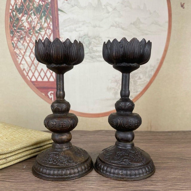 This elegant pair of bronze candlesticks features a lotus flower design, a traditional symbol of purity and enlightenment....