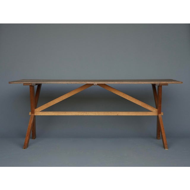 A very nice X-frame table with a simple construction. An oak board top and cherry wood frame legs. The thin oak and peg...