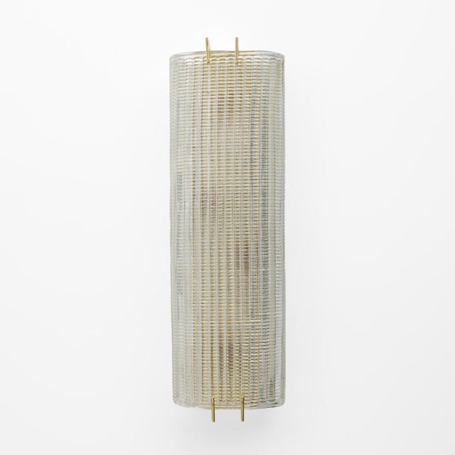 Pair of textured clear Murano glass sconces. The glass is fluted and curved, creating a superb impact encased in a sheet...