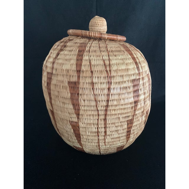 This is a stunning, authentic hand-woven African coiled basket with its original matching lid. Standing an impressive 10.5...