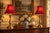 A matched pair of vintage Stiffel brass table lamps with a graceful candlestick silhouette, turned bodies, and broad...
