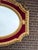 An elegant 1970 French Louis XVI–style wall mirror, crafted with a richly carved wooden frame, warm antique gold finish,...