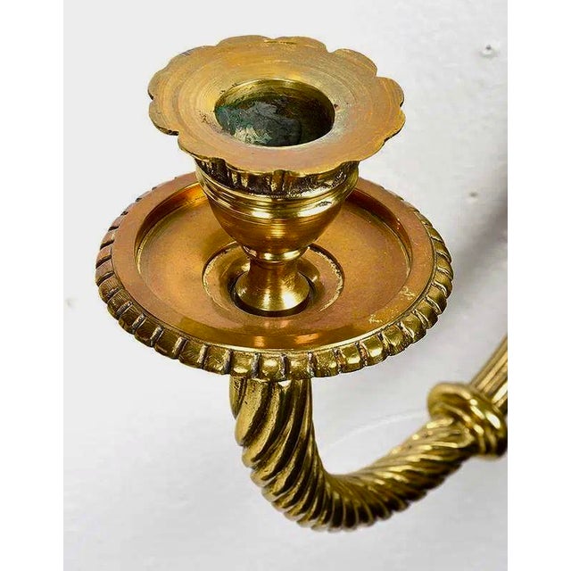 Elegant pair of Louis XVI style polished brass sconces