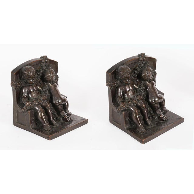 This is a beautiful antique pair of patinated bronze classical cupid bookend sculptures, circa 1880 in date. These...