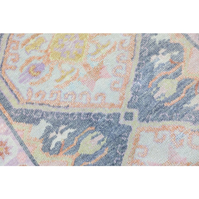 This modern Turkish Oushak rug is a stunning piece of art that has been handwoven using traditional techniques by skilled...