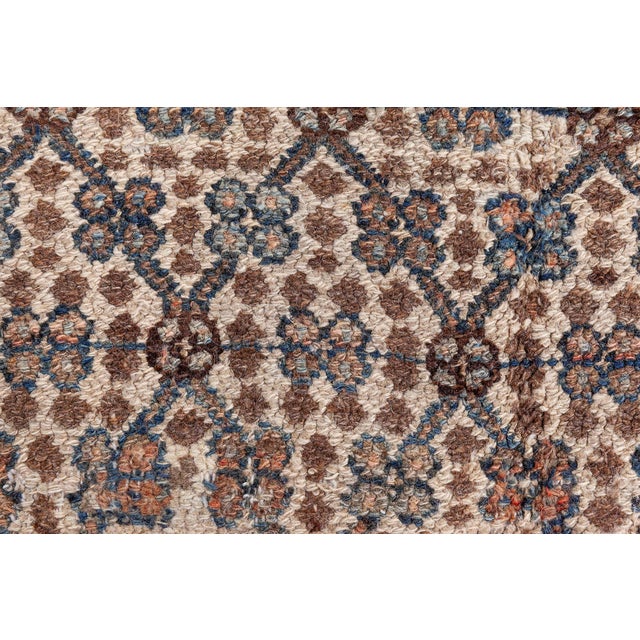 An antique Persian Hamadan rug, hand-knotted in wool and dating back to circa 1910. The main field carries a finely-woven...