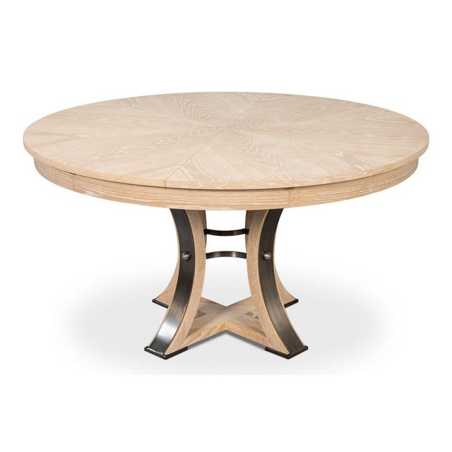 Bleached wood and dark iron bands give the open pedestal definition while keeping the overall palette light. A curved...