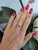 A natural red spinel glows with vivid, fiery red at the centre of this solid 14K white gold ring, framed by ten earth-...