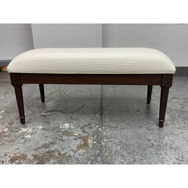 Design Plus Gallery presents an Upholstered Bench from Shermag. This bench has a cream textured fabric seat with a subtle...