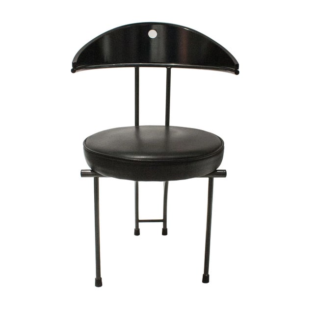 Set of four contemporary chairs attributed to Philip Stark. The chairs are composed of a black lacquered iron structure...