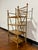 Antique English bamboo etagere featuring a scorched or burnt bamboo frame and four shelves. In the style of Victorian or...