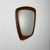 Rare organically shaped wall mirror with a thick frame made of solid teak wood.