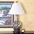 Vintage American-made Chinoiserie porcelain table lamp featuring a hand-painted floral garden design on a creamy white...