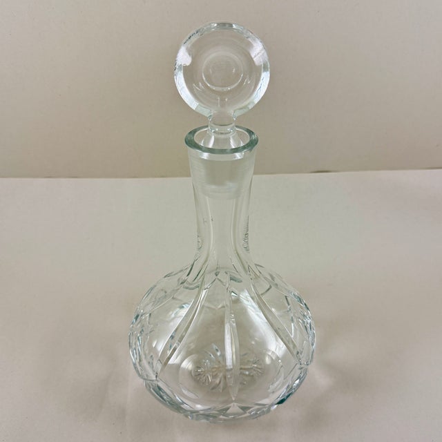 A vintage cut crystal decanter in the Ship Captains shape, with a top round stopper, circa early 1980s. The term “captains...