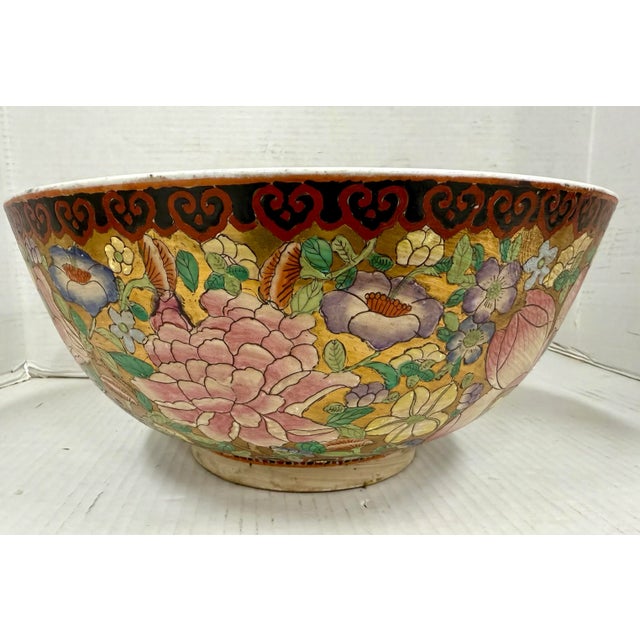 Exquisite Chinese hand-painted porcelain bowl, features an all-over floral motif in vibrant hues of pink, green, lavender,...