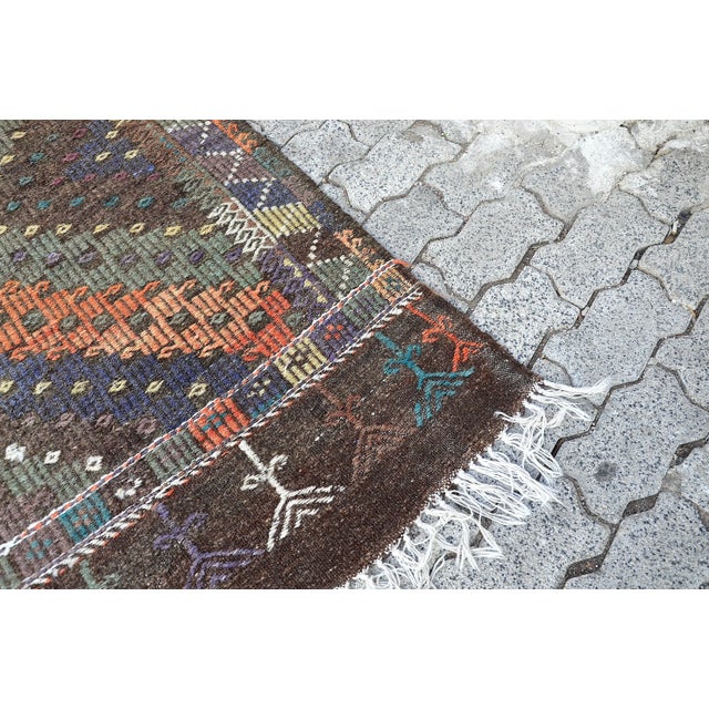 This is a vintage Turkish Anatolian kilim rug from the 1960s. The piece was hand-woven.