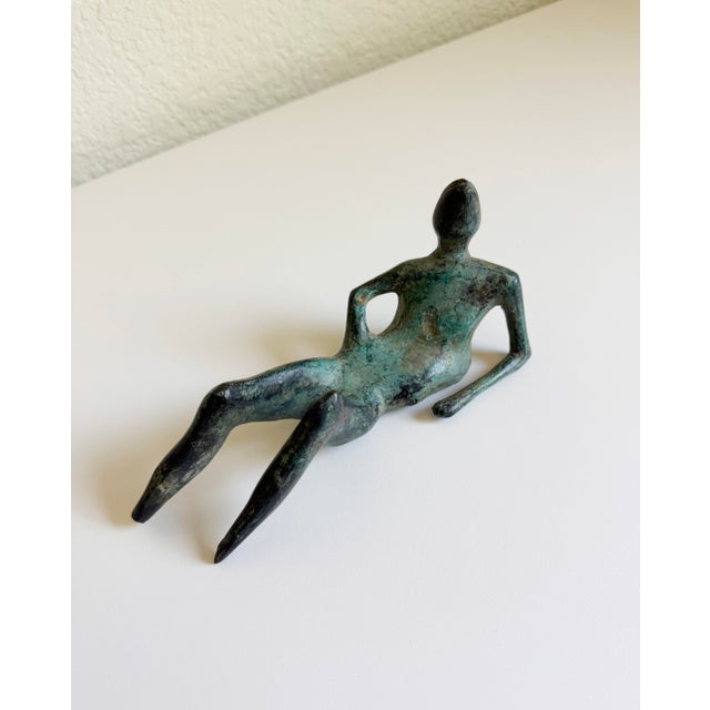 An abstract bronze modernist sculpture created in the distinctive style of the renowned British sculptor Henry Moore and...