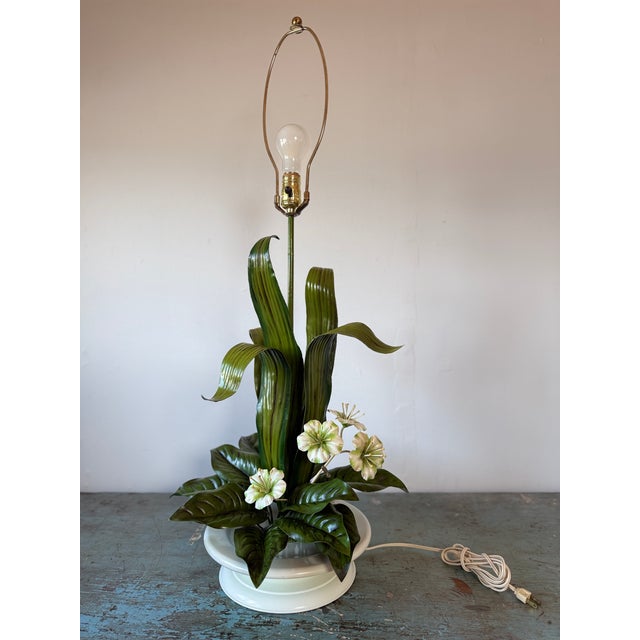 Dramatic Vintage Tole Lamp by Safran & Glucksman with White Flowers and Green Shiny Leaves, sit on a White Tole Base....