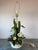 Dramatic Vintage Tole Lamp by Safran & Glucksman with White Flowers and Green Shiny Leaves, sit on a White Tole Base....
