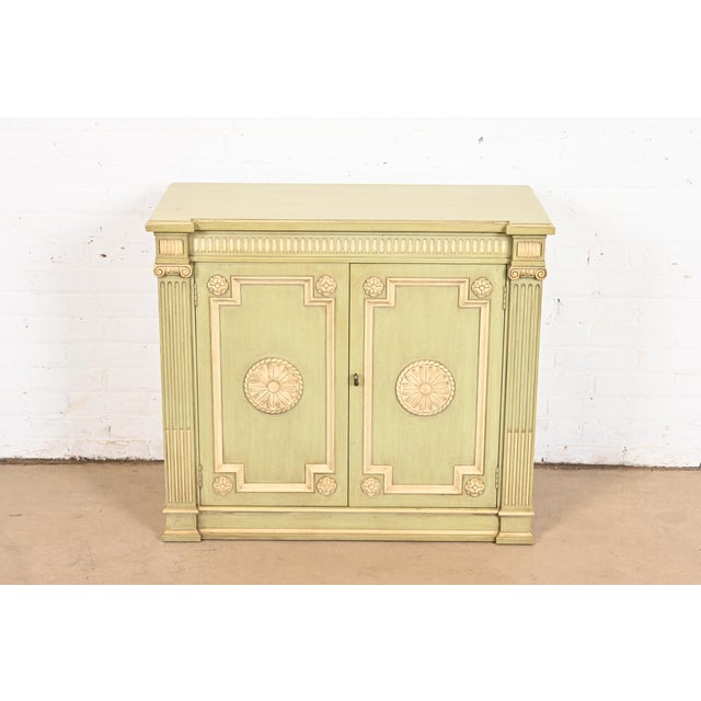 A gorgeous Neoclassical or Louis XVI style sideboard buffet, bar cabinet, or compact credenza By Henredon USA, Circa 1960s...