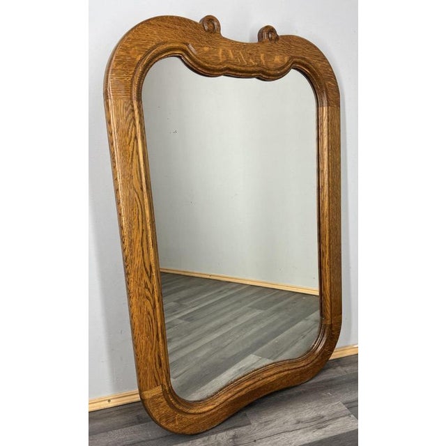 This elegant Vintage French mirror features a beautifully shaped oak frame with flowing curves and warm grain patterns...
