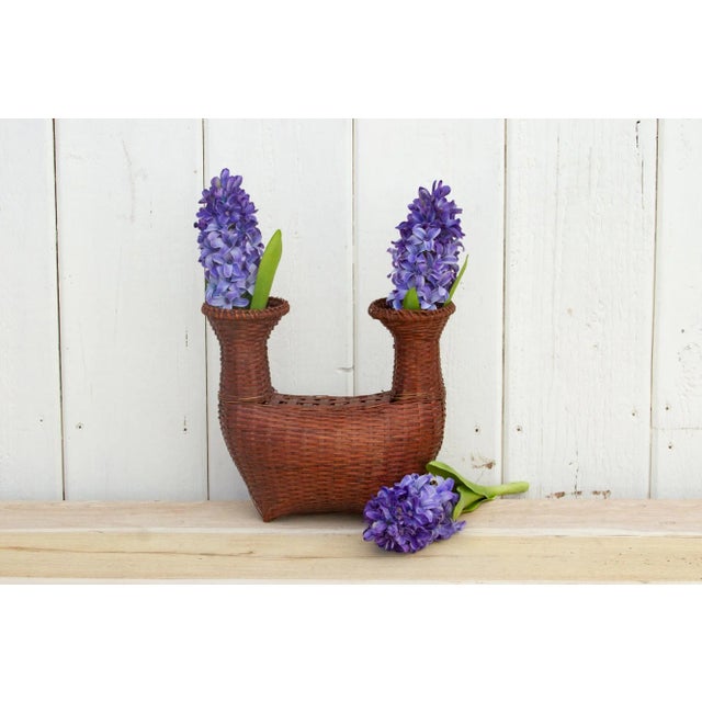 This antique woven basket from Thailand has a boat shape with a rounded body and two narrow neck openings. This old Thai...