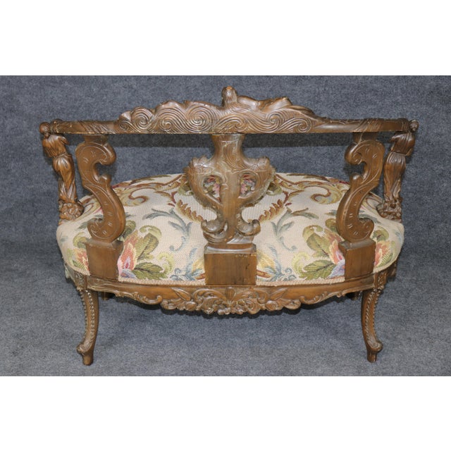 Remarkable, sculptural, and richly expressive, this early 20th century Italian carved figural chair settee is a masterful...