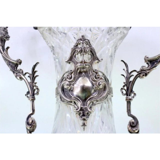 Silver and Cut Glass Vase with Raised Floral Motifs and Cut-Out Base, in Very Good conditions. Designed before 1890 This...
