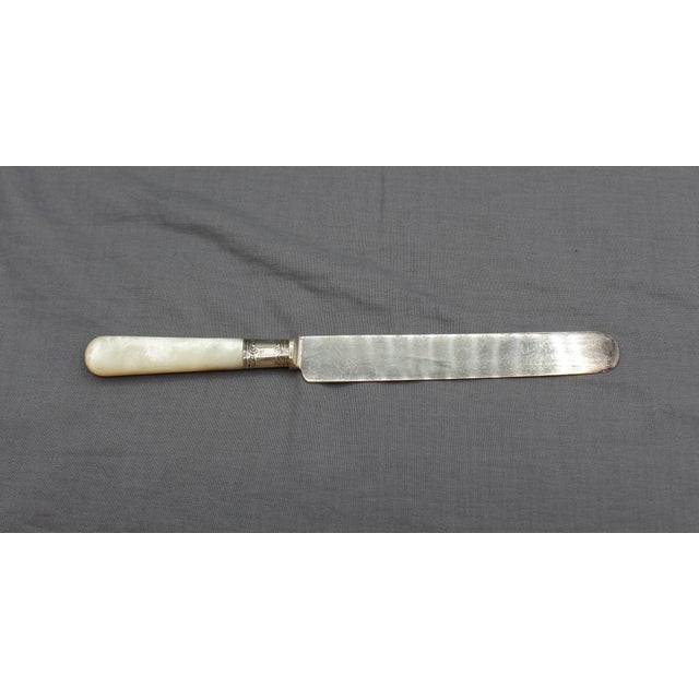 A set of 12 dinner knives, American, c. 1900, by Northampton Cutlery Co. Mother of pearl handles with sterling ferrules. 6...