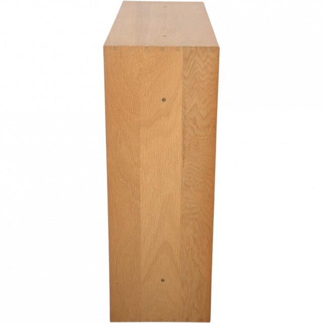 Mogens Koch bookcase made of oak, and from the 1980s. The bookcase appears with some marks and scratches. •Designer:...