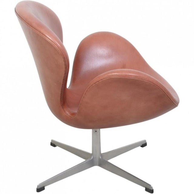 Arne Jacobsen vintage swan chair upholstered in red anilin leather. The chair is from the early 1960s but was later...