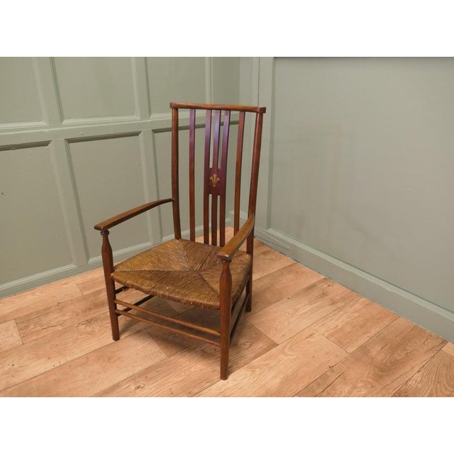 A Liberty Morris & Co Rush Seated Low Armchair This piece is being offered from a dispersal sale of Arts and Crafts,...
