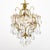 Antique brass and crystal chandelier from France. This piece has a brass structure with lovely curving forms. The...
