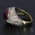 Here is a 14k Yellow Gold Cocktail Ring featuring a 9.0ct Oval Ruby Cabochon Center stone, accented by White Diamonds....