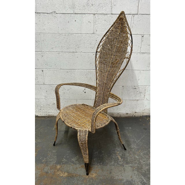 Vintage high back wicker and iron accent chair Attributed to Danny Ho Fong and his son Miller Fong for Tropic-Cal. The...