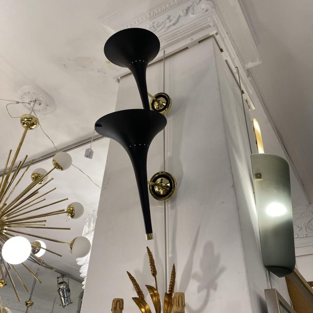 Pair of Italian metal wall lights from the 1970s. They are trumpet-shaped and lacquered both inside and out. The exterior...