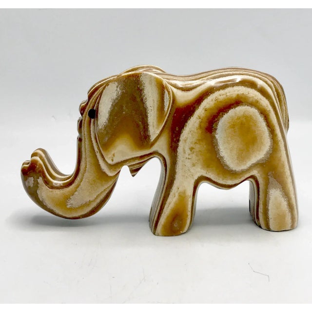 Mid century modernist carved fossil wood agate elephant. This 1960s piece is polished bright. The stone from a fossilized...
