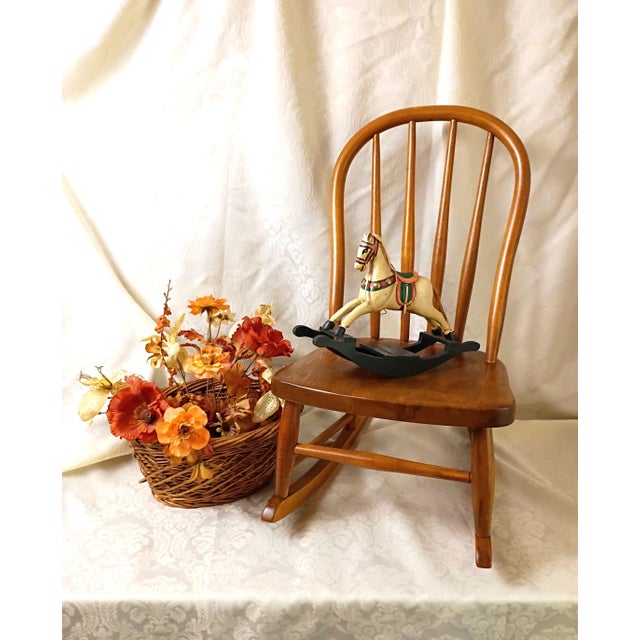 This vintage solid birch child-size Windsor hoop-back rocking chair beautifully captures the timeless elegance, storied...