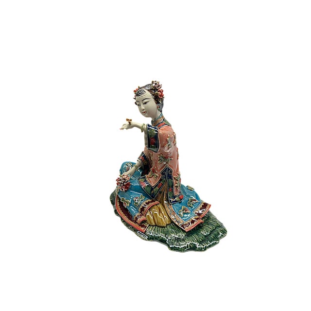With intricate detail and vibrant color, this exquisite porcelain figurine captures a moment of serene elegance. The...