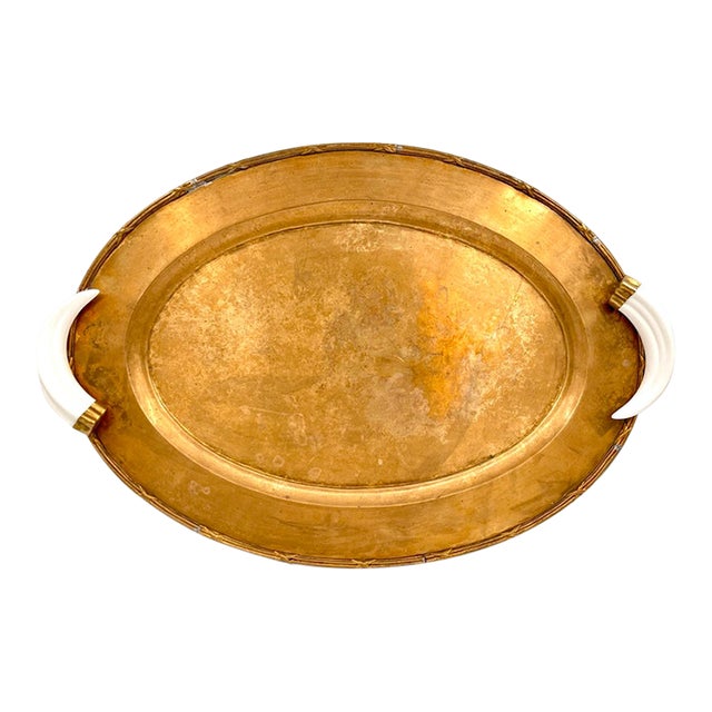 Vintage Italian Hollywood Regency Oval Statement Size Brass Tray With Faux Boar Tusk Handles and Cross Strap Trim For Sale