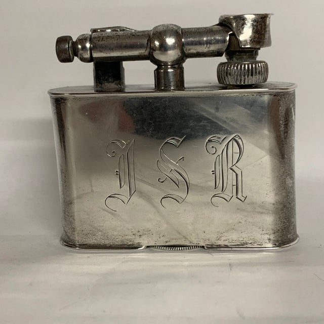 Heavy vintage table lighter engraved on front with the initials "I S R." It is stamped sterling on the back of the latch...