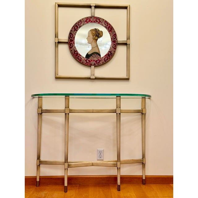 This elegant and unusual Italian Renaissance style console and matching mirror likely date to the 1940s. The wood frames...
