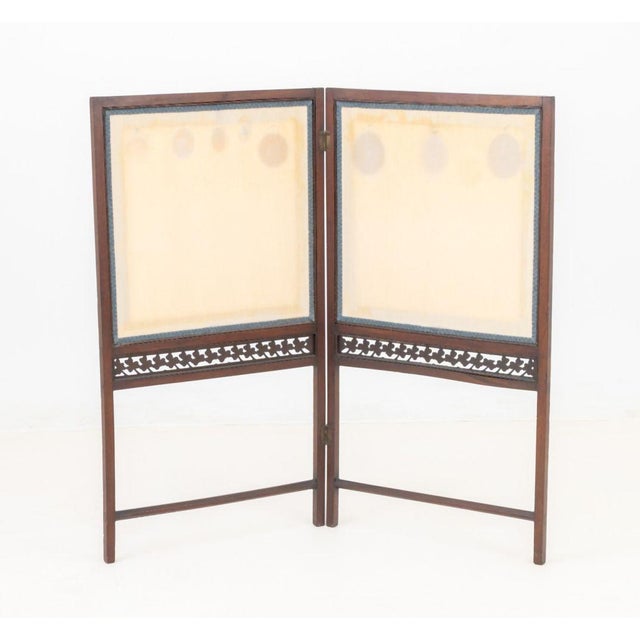 British Mahogany and Beige Silk Two-Panel Folding Screen, probably Irish, with blue trim and with carved clover border....