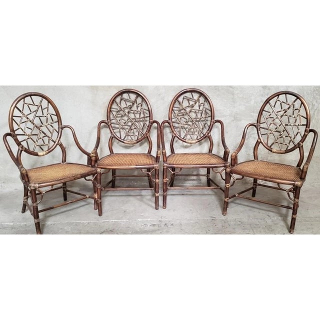 A striking set of four vintage McGuire of San Francisco dining armchairs featuring the distinctive "cracked ice" back...