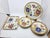 This magnificent 1970s dinner service, featuring a multicolored floral design, consists of 10 dinner plates and two...