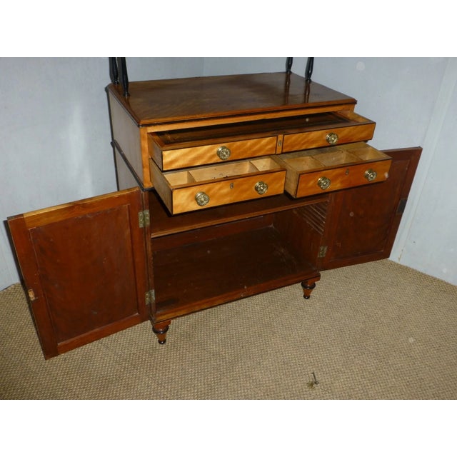 An exquisite English Regency period satinwood secretaire chiffonier cabinet, circa 1810, attributed to the renowned...