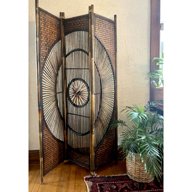 Midcentury 3-panel bamboo wicker folding screen room divider with a sunburst motif. Rare and striking design. Most items...