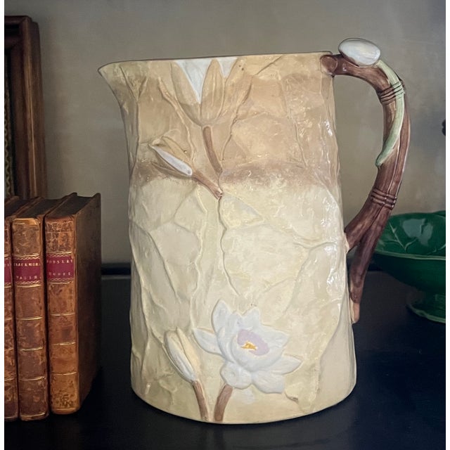 Antique pitcher made by Joseph Holdcroft around the 1880's. The large oval pitcher has overlapping pond lily leaves with a...